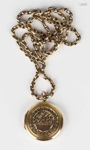 A gold back and front circular pendant locket with foliate and scroll engraved decoration, the