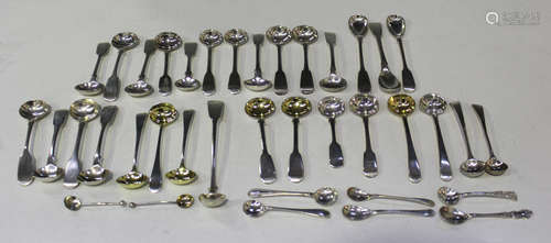 A collection of Georgian and Victorian silver condiment spoons, including a set of three salt spoons