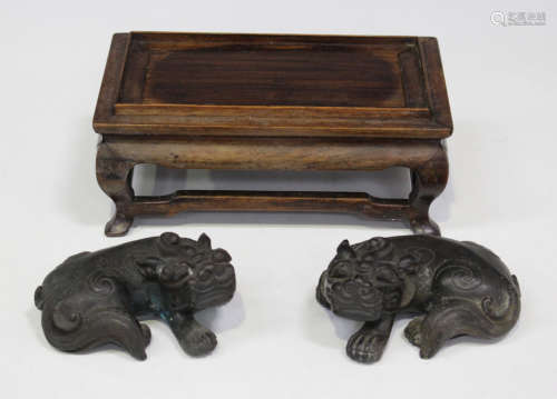 A pair of Chinese brown patinated cast bronze figures of kylin, Qing dynasty, each modelled in a