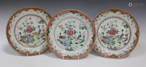 A set of three Chinese famille rose export porcelain plates, Qianlong period, each painted with a