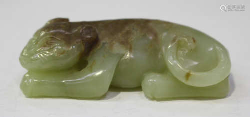 A Chinese Ming style jade carving, modelled as a sleeping cat, the stone of celadon tone with russet