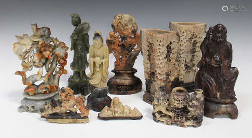 A collection of Chinese soapstone carvings, mostly early 20th century, the majority spill vases