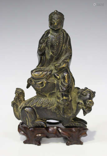 A Chinese bronze figure of a bodhisattva, seated upon a mythical beast, Ming style but probably