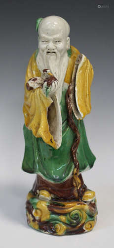 A Chinese sancai glazed biscuit porcelain figure of Shoulao, Kangxi style but 19th century, modelled