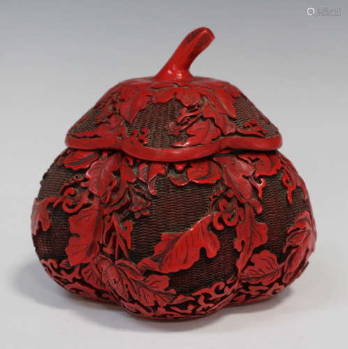 A Chinese red lacquer box and cover, 20th century, in the form of a gourd, decorated in relief