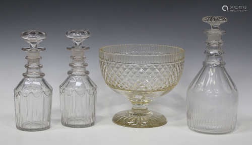A pair of triple ring neck glass decanters and stoppers, 19th century, each with facet cut