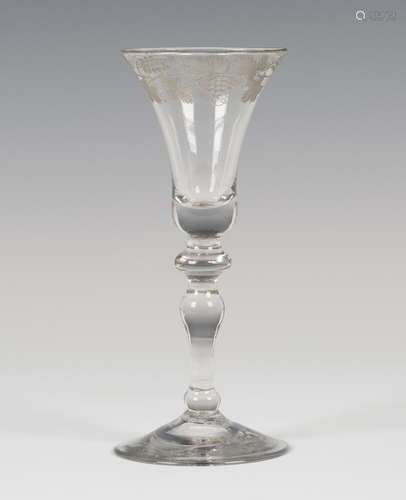 A Newcastle type engraved light baluster wine glass, circa 1750, the bell bowl engraved to the rim