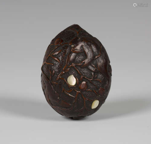 A Japanese carved wood box and cover, Meiji period, of peach outline, carved in low relief with