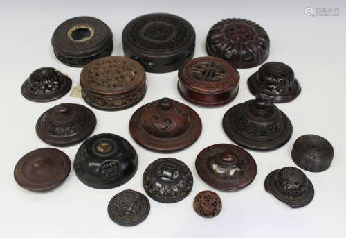 A collection of eighteen Chinese hardwood covers/lids, late 19th and 20th century, of various sizes,