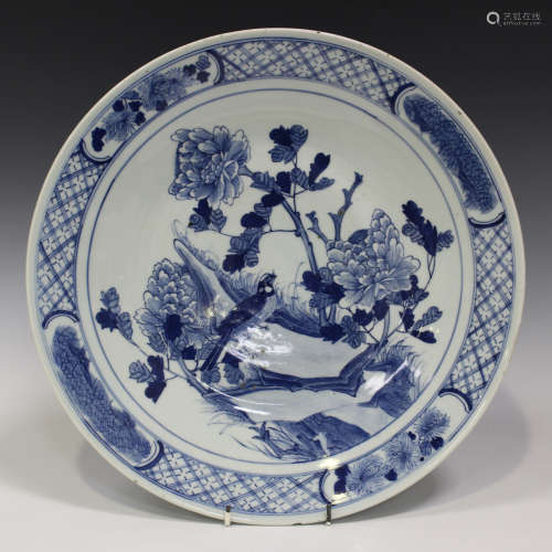 A Chinese blue and white porcelain circular dish, late 19th century, painted with a bird amongst