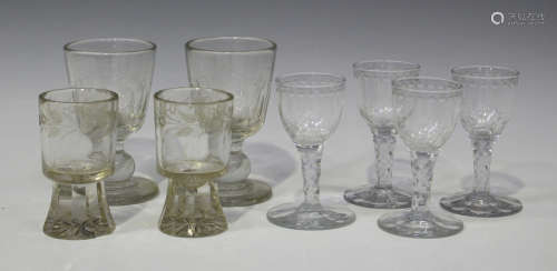 A set of four wine glasses, early 19th century, each round funnel bowl with basal fluting and