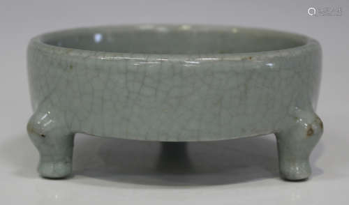 A Chinese Jun-type crackle glazed tripod censer of shallow cylindrical form, on scroll legs,