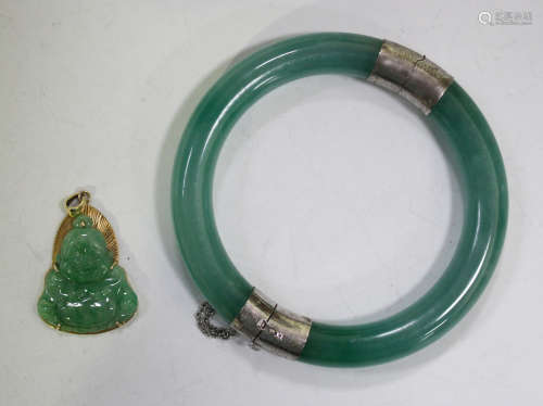 A Chinese gold mounted green jadeite pendant, carved in the form of Buddha, the mount detailed '