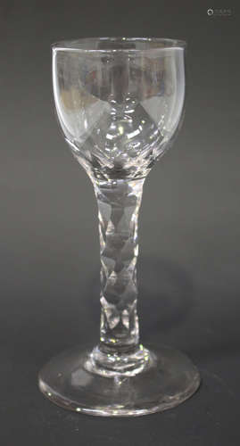 A faceted stem wine glass, circa 1785, the rounded bowl raised on a plain stem with diamond shaped