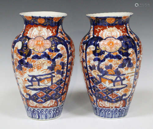 A pair of Japanese Imari vases, Meiji period, of high shouldered ribbed form, decorated with