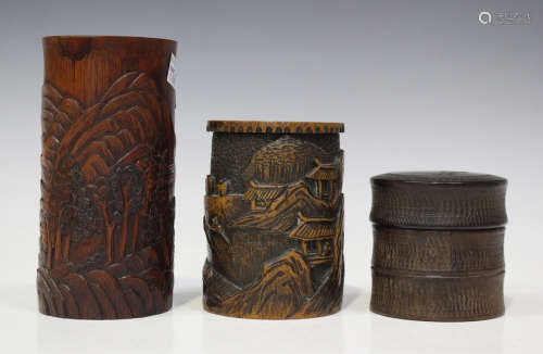A Chinese bamboo brushpot, early 20th century, carved in relief with pavilions, trees and rocks,