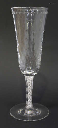 An ale glass, circa 1765, the rounded funnel bowl with hammered moulded detail beneath an engraved