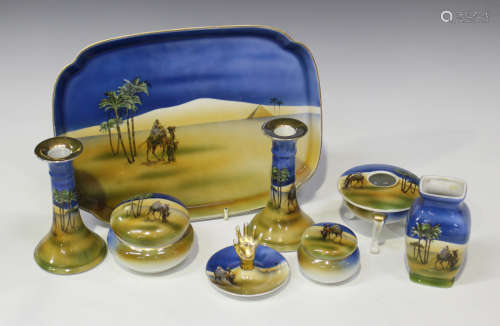 A Noritake porcelain dressing table set, decorated with Eastern scenes, including a tray, a pair