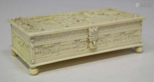 An Indian ivory rectangular box, late 19th century, the hinged lid carved in low relief with a scene