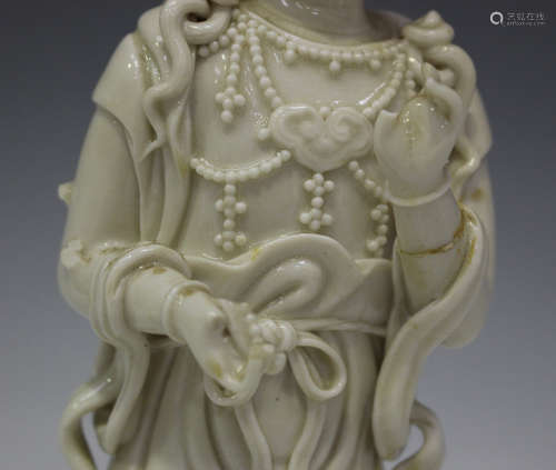 A Chinese blanc-de-Chine porcelain figure of Guanyin, Qing dynasty, modelled seated upon the back of