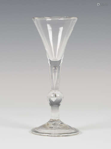 A baluster wine glass of kit-kat (or kit-cat) type, circa 1740, the drawn funnel bowl above the