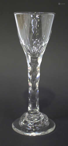 A faceted stem wine glass, circa 1785, the pointed rounded funnel bowl with lower faceted detail