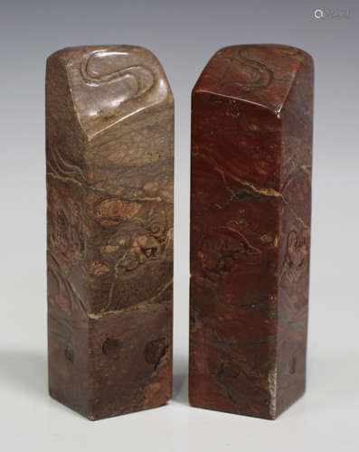 A pair of Chinese soapstone seals, 20th century, each carved with mythical beasts and waves,