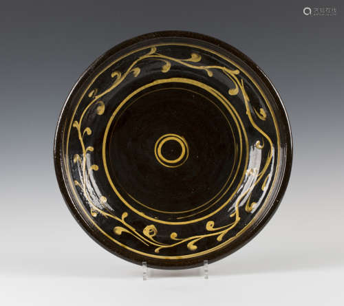 A Clive Bowen studio pottery shallow bowl, the dark brown glazed body with yellow slip decoration,