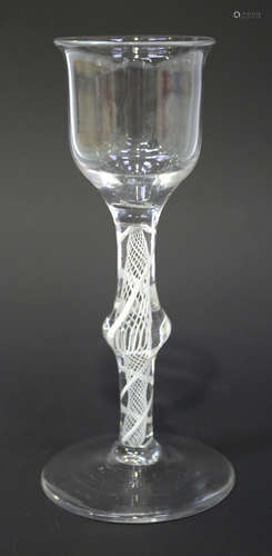 A double series opaque twist stem wine glass, circa 1770, the lipped ogee bowl raised on a centrally