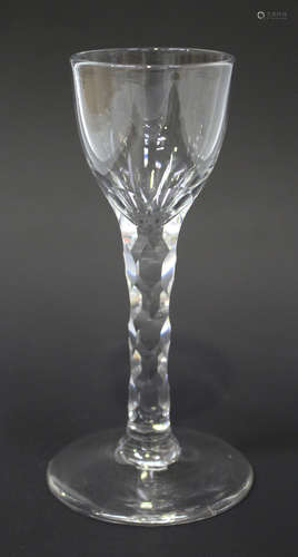 A faceted stem wine glass, circa 1785, the rounded funnel bowl above a plain stem with hexagonal