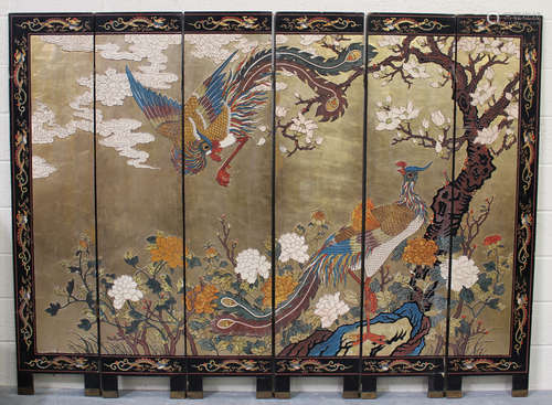 A Chinese lacquered six-fold screen, late Qing dynasty, one side carved in low relief and polychrome