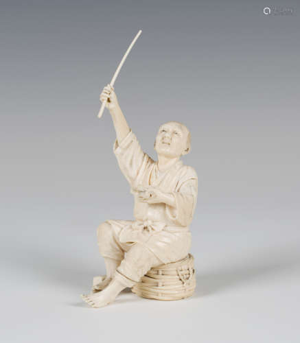 A Japanese carved ivory okimono figure of a fisherman, Meiji period, modelled seated on a wicker