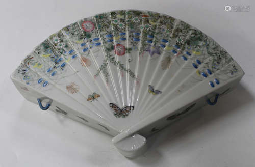 A Japanese porcelain hanging vase, Meiji period, of fan form, painted with butterflies and