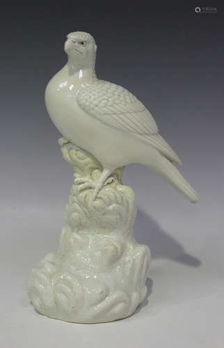 A Chinese white glazed model of an eagle, Qing dynasty, modelled perched on a high rock with