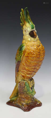 A Continental pottery model of a cockatoo, 20th century, decorated in shades of orange, yellow and