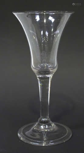 A balustroid wine glass, circa 1750, the bell bowl above a plain stem with basal ball knop on the