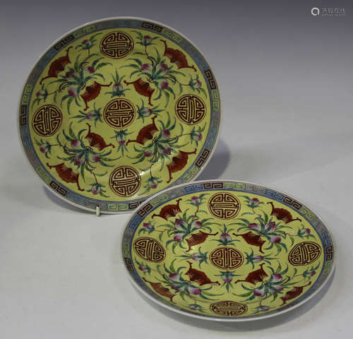 A pair of Chinese famille rose enamelled yellow ground porcelain plates, mark of Qianlong but 20th