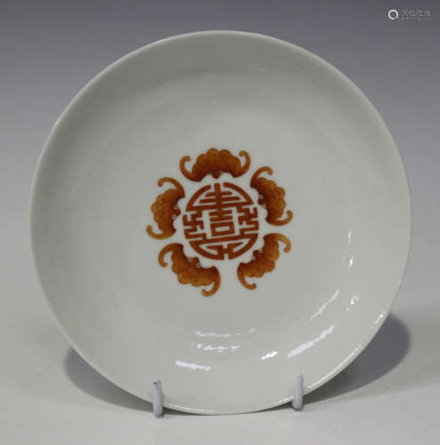 A Chinese porcelain saucer dish, mark of Jiaqing but later, the interior painted with iron red