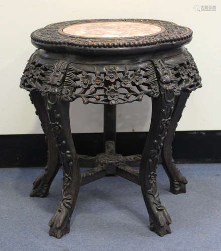 A Chinese hardwood low stand, late Qing dynasty, the lobed top inset with a rouge marble panel