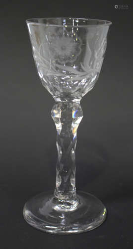 A faceted stem wine glass, circa 1785, the rounded funnel bowl engraved and polished with a