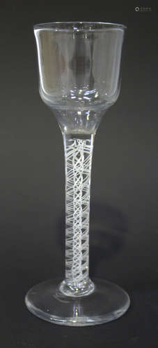 A double series opaque twist stem wine glass, circa 1770, the ogee bowl raised on a plain stem