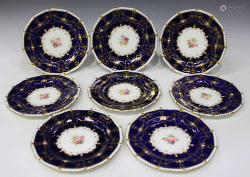 A set of eight Derby porcelain plates, circa 1911, each centrally painted with pink roses framed