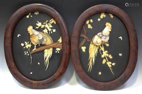 A pair of Japanese inlaid lacquer oval panels, early 20th century, each black ground inlaid in bone,