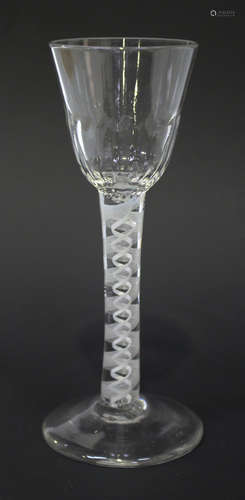 A double series opaque twist stem wine glass, circa 1770, the rounded funnel bowl moulded with basal