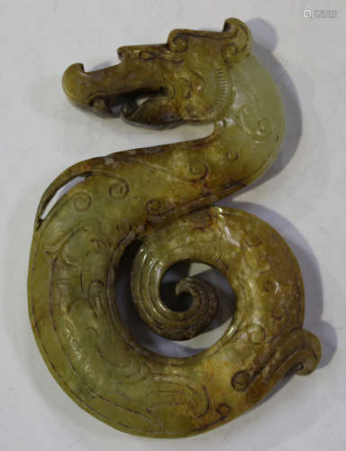 A Chinese archaistic jade dragon pendant, Warring States style but probably Qing dynasty, carved and