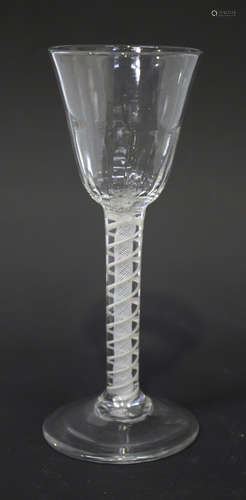 A double series opaque twist stem wine glass, circa 1770, the rounded funnel bowl moulded with basal