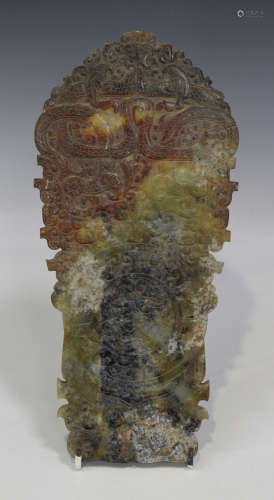 A Chinese archaistic jade plaque, one side carved in low relief with mask and scroll motifs, the