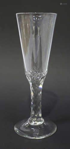 A faceted stem ale glass, circa 1785, the rounded funnel bowl with lower faceted detail above the