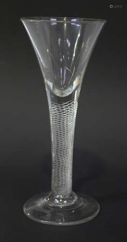 An airtwist stem wine glass, circa 1750, the drawn trumpet bowl raised on a plain stem with multi