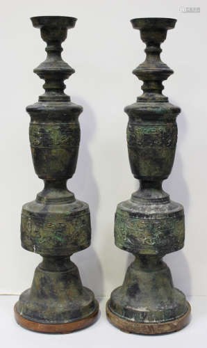 A pair of Chinese archaistic bronze lamp bases, 20th century, each decorated with bands of taotie